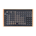 Neutral Labs Luna modular synthesizer desktop unit with multiple knobs, toggle switches, and audio jacks in a wooden frame.