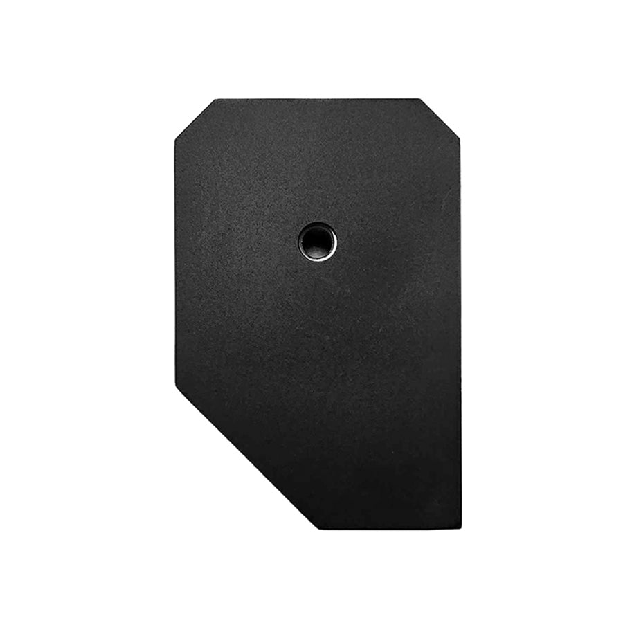 Black irregular shaped flat object with a round hole in the center on a white background.