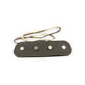 Black guitar pickup with four metal pole pieces and white/black wires attached on a white background.