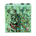 Green guitar effects pedal with multiple knobs and two footswitches labeled AUX and ON/OFF.