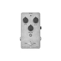 Gray guitar effects pedal with three knobs, a toggle switch, a footswitch, and two side jacks.