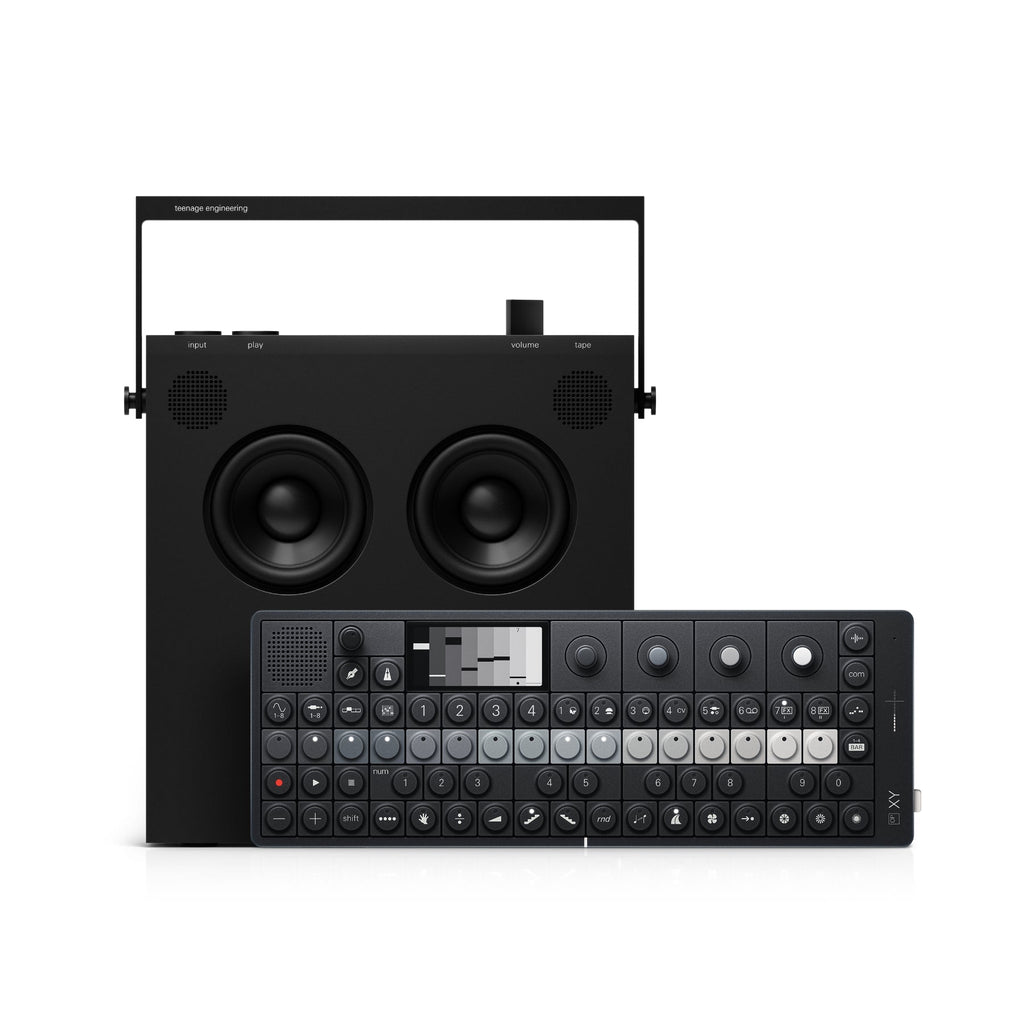 Black synthesizer device with buttons and screen in front of a black speaker unit with handle and speakers.