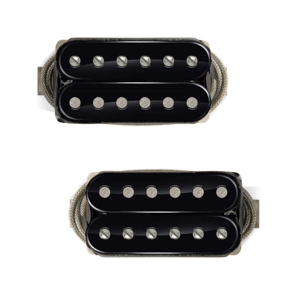 Two black humbucker pickups with six pole pieces each and fabric-sleeved wires attached.