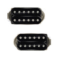 Two black humbucker pickups with six pole pieces each and fabric-sleeved wires attached.