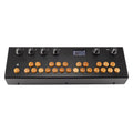 Black electronic device with wooden buttons, rotary knobs, and a small screen showing settings.