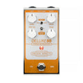 Silver and orange rectangular guitar effect pedal with four knobs, two toggle switches, one footswitch, and input/output jacks.