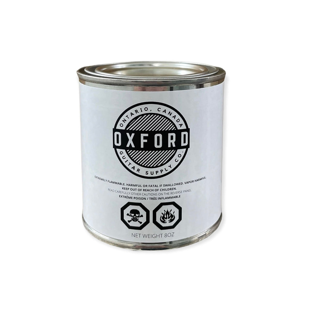 Metal can with white label featuring Oxford brand and safety warnings, net weight 8oz.