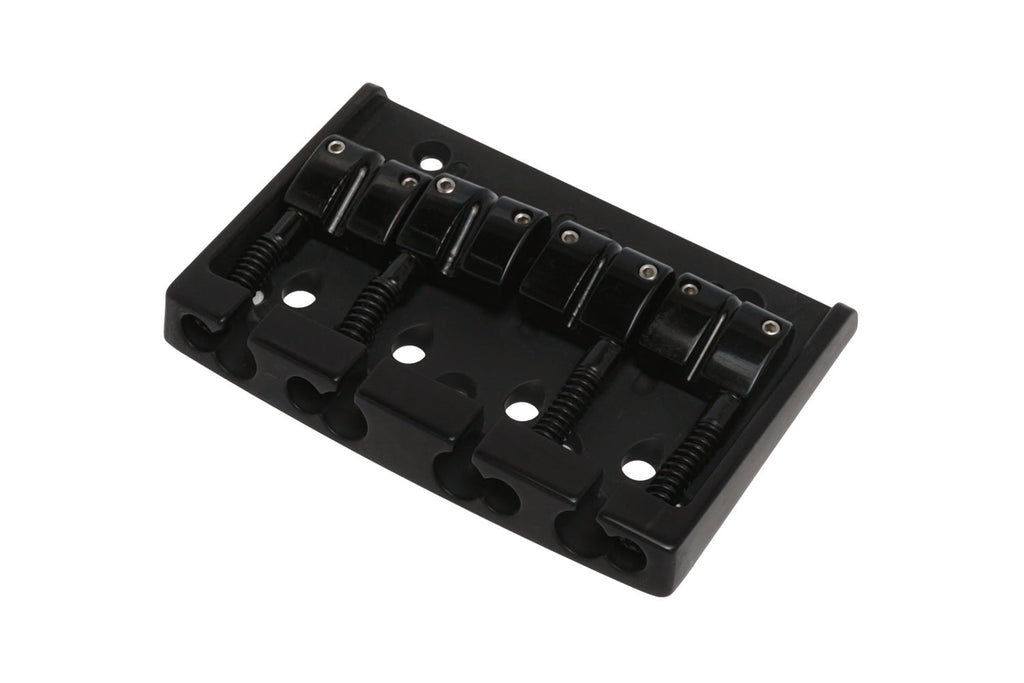 Black metal bridge component with four saddles and adjustment screws for string spacing.