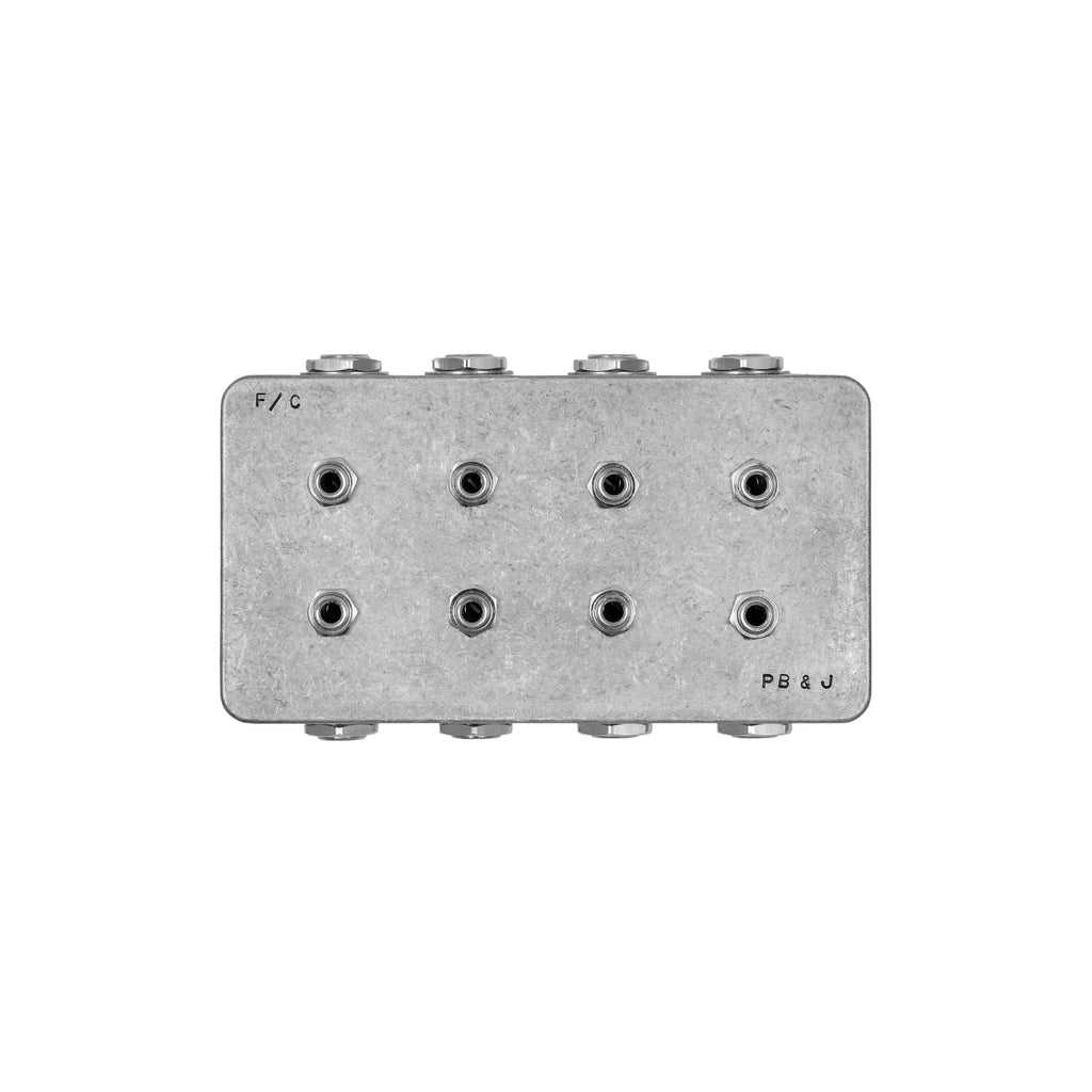 Metallic compact patchbay with eight audio jack sockets arranged in two rows.