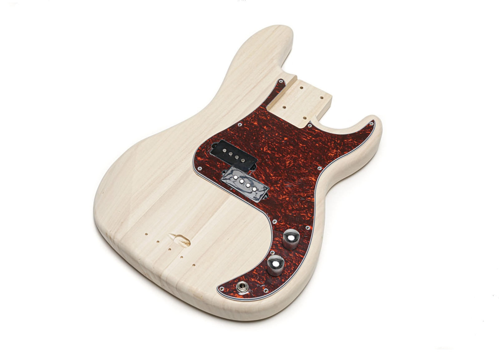 Natural wood bass guitar body with tortoiseshell pickguard, two pickups, two control knobs, and a switch.
