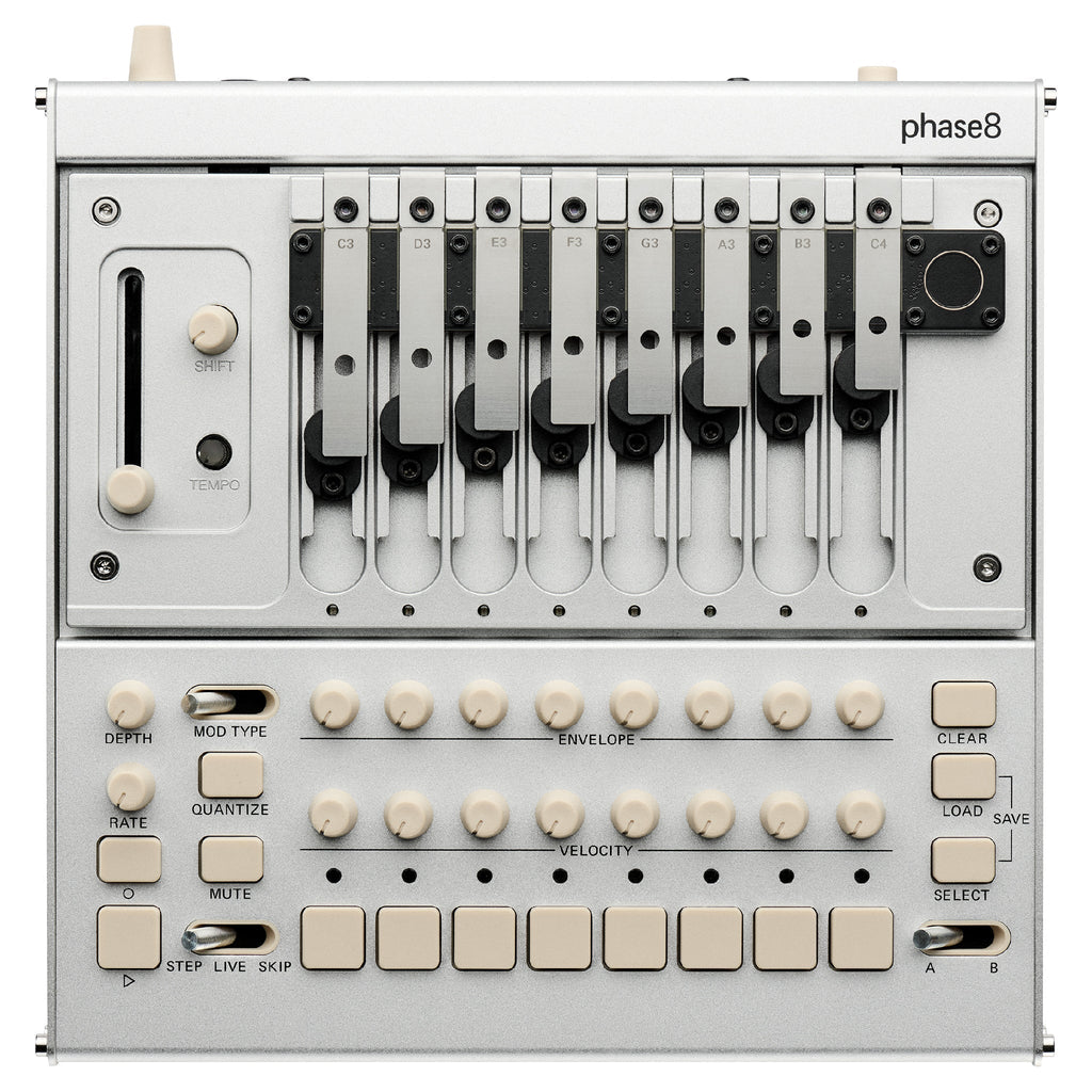 Top view of a silver Korg Phase-8 synthesizer with nine metal keys and multiple knobs, buttons, and sliders.