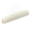 White slotted nut piece for stringed instrument with four slots for strings.