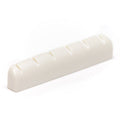 Off-white plastic guitar nut with six string slots angled on white background.