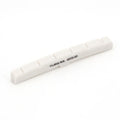 White slotted curved guitar nut with the text 'TUSQ XL 5072-00' printed on it.