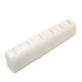 White slotted rectangular guitar nut with six slots on the top surface