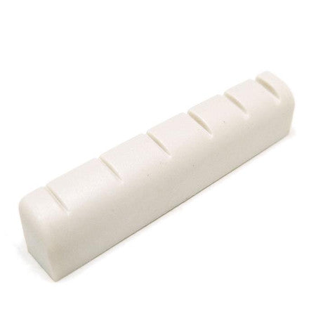 White slotted rectangular guitar nut with six slots on the top surface