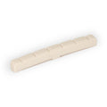 Off-white slotted guitar nut with several evenly spaced slots along its length.