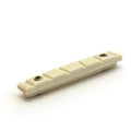 Off-white guitar nut with six string slots and two small metal screws on a white background.