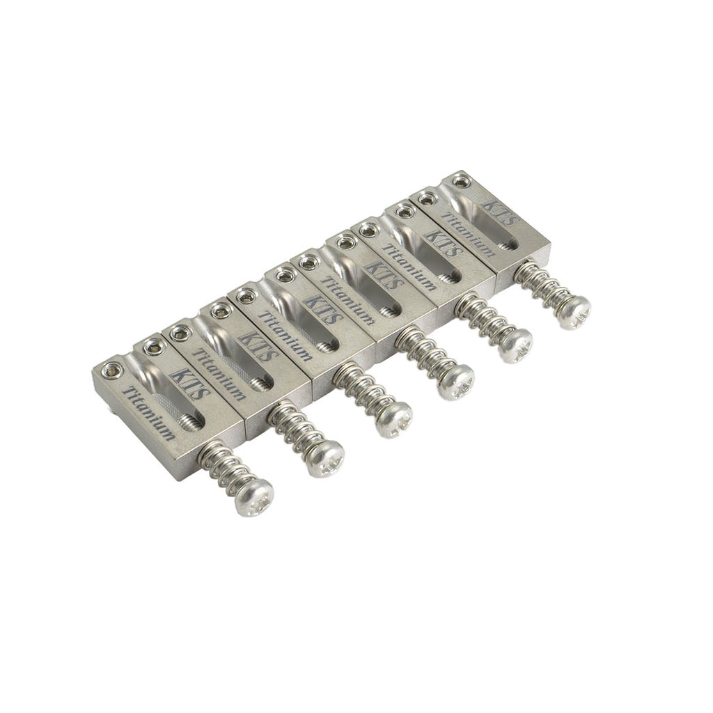 Six silver metal block-style saddles with springs and screws arranged in a row on a white background.