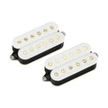 Two white humbucker guitar pickups with gold pole pieces and black bases on a white background.