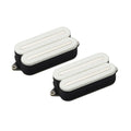 Two white and black rectangular guitar pickups with fabric sides and visible mounting holes.