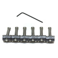 Six black metal barrel saddles in a row with an allen wrench above them on a white background.