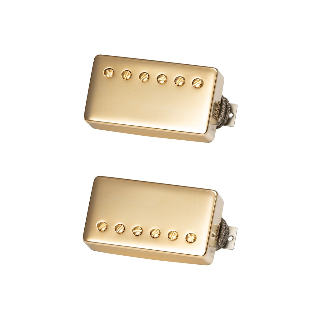 Two gold-colored humbucker pickups with braided wire leads and adjustable pole screws