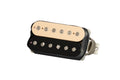 Zebra-colored guitar humbucker pickup with cream and black coils and braided wire leads.