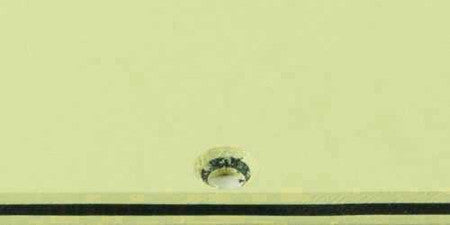 Small portion of a mint green pickguard blank against a plain background.