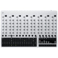 Silver electronic drum machine with multiple control knobs, sliders, and pads arranged on a flat surface.