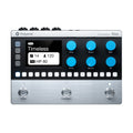 Black and silver drum machine with blue knobs, LED display, white touchpads, and three footswitches.
