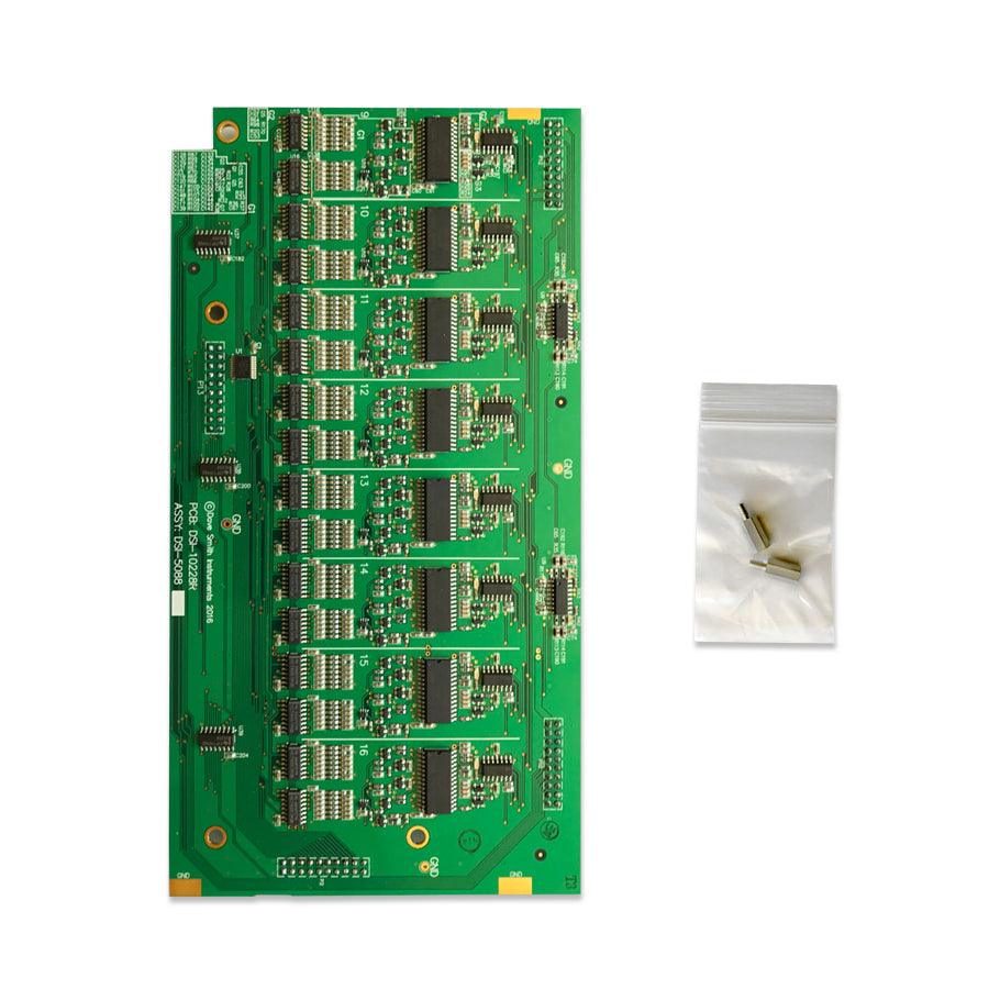 Green printed circuit board with multiple integrated circuits and a small plastic bag containing three metal standoffs.