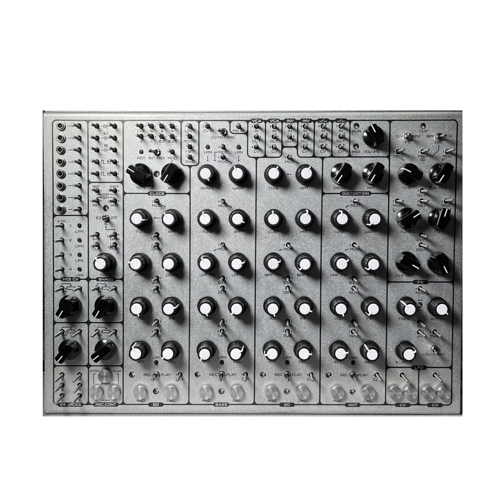 Top-down view of a silver drum machine with multiple knobs, toggle switches, and input/output jacks