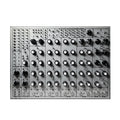 Top-down view of a silver drum machine with multiple knobs, toggle switches, and input/output jacks