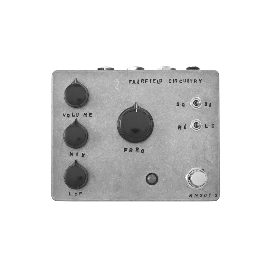 Gray rectangular guitar effect pedal with black knobs, toggle switches, 1/4 inch jacks, and a footswitch.