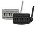 Two guitar tremolo bridge units in chrome and black finishes with attached tremolo arms, showing string saddles and springs.