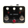 White and black audio effects pedal with three knobs, two footswitches, and two red LEDs.
