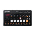 Black Roland P-6 music device with various buttons, knobs, white pads, and connectors on a white background.