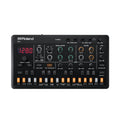Top view of a Roland S-1 synthesizer with multiple knobs, buttons, a digital display, and audio input/output jacks.