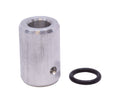 A silver cylindrical metal piece with a hole and a small hole on its side is shown next to a black rubber ring.