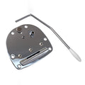 Chrome metal tremolo tailpiece plate with attached screws and a separate chrome tremolo arm with a white tip.