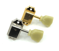 Two vintage style guitar tuning pegs, one gold and one silver, with cream-colored plastic knobs.