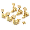 Set of six gold guitar tuning pegs with matching screws arranged on a white background.