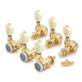 Set of six gold guitar tuning pegs with white knobs and included gold screws.