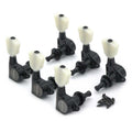 Set of six black guitar machine heads with white tuning knobs and a small pile of screws.