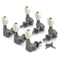 Set of six black metal guitar tuning pegs with white tuning knobs and mounting screws on a white background.