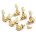 Set of six gold tuning pegs with white knobs and accompanying screws for string instrument tuning.