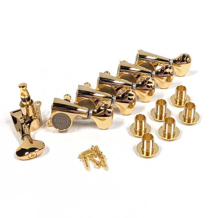 Set of six gold guitar tuning machines with mounting bushings and screws arranged on white background.