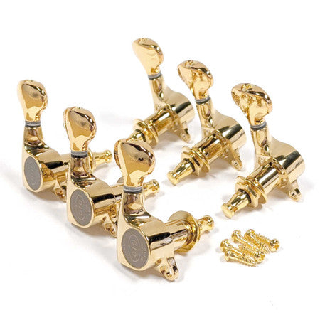 Set of six gold guitar tuning pegs with three mounting screws on a white background
