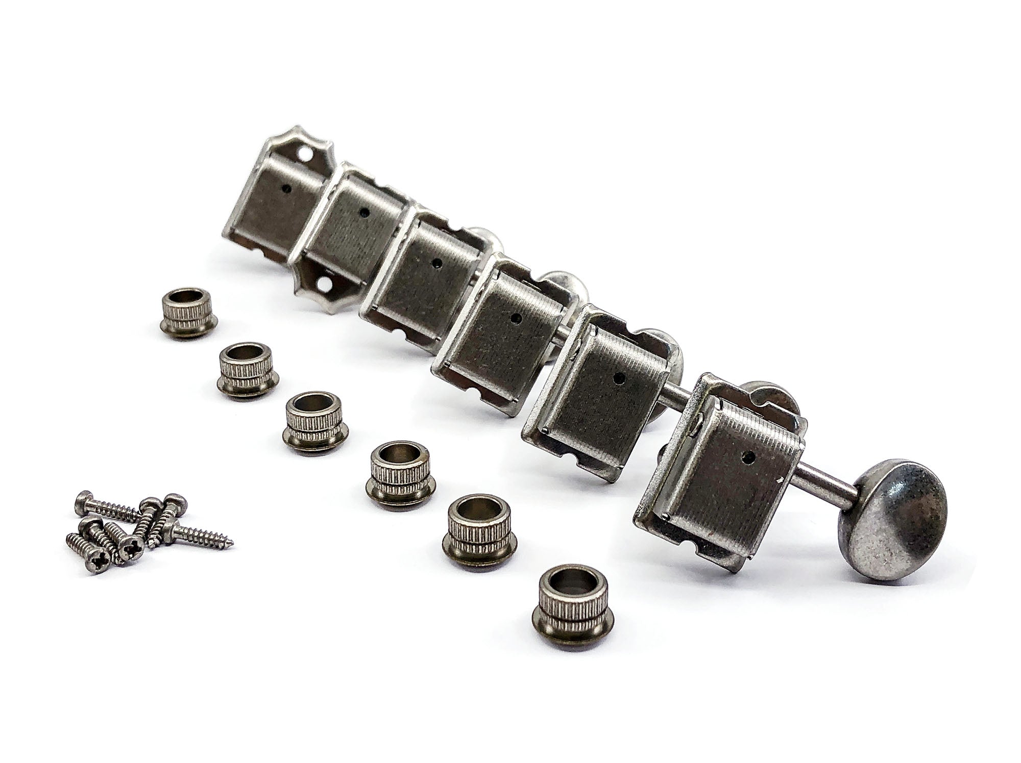 Set of six metal inline guitar machine heads with oval buttons, bushings, and screws on a white background.